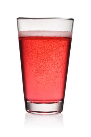 Glass of red soda soft drink with bubbles of gas isolated on white background.の写真素材