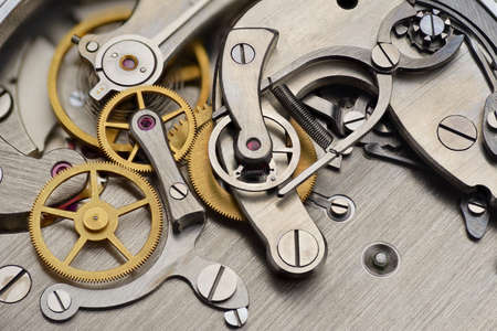 Analog mechanical stopwatch mechanism gears inside. Macro shot.