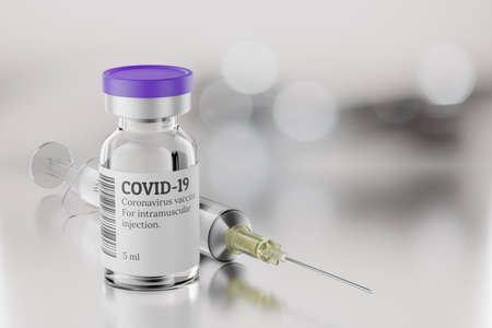 COVID-19 vaccine vial and disposable syringe for injection on gray blur background. Vaccination...