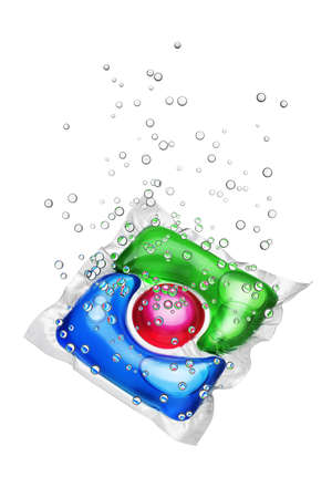 Laundry detergent pod red, blue and green colored with bubbles isolated on white backgroundの写真素材