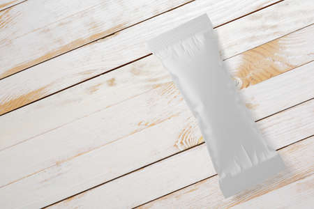 Ice-cream bar clean package mock-up on white wood plank. 3D rendering illustration.の写真素材