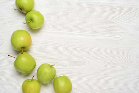Green apples on the white wooden table. Top view with copy space,の写真素材