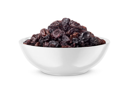 Black raisin in white bowl isolated on white background. Front view.の写真素材