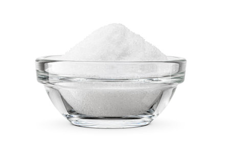 Fine ground salt in glass transparent bowl isolated on white background. Side view.の写真素材