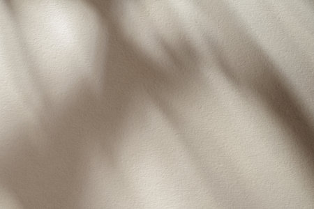 Tan rough paper texture or background with lights and shadows.の写真素材