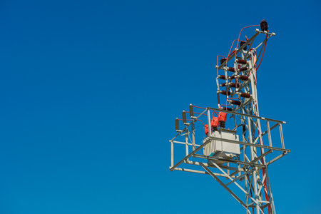 High voltage power transformer on clear blue sky with copy space.