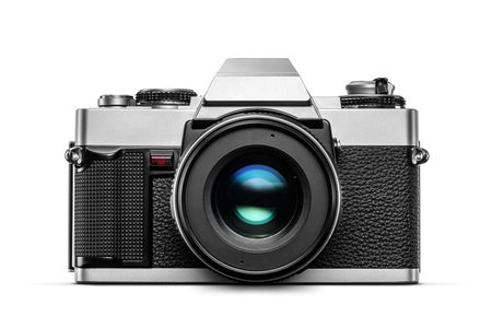 Vintage analog film camera with lens isolated on white background, front view.