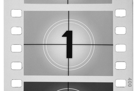 Classic film leader countdown with number one on screen, creating a vintage cinema concept, isolated on white background.の写真素材
