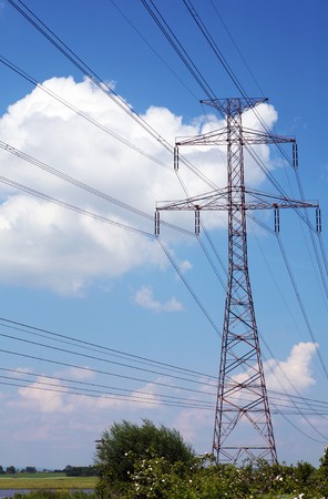 Electric pylons and wires on the cloudy skyの写真素材