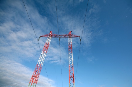 Electric pylons and wires on the cloudy sky 