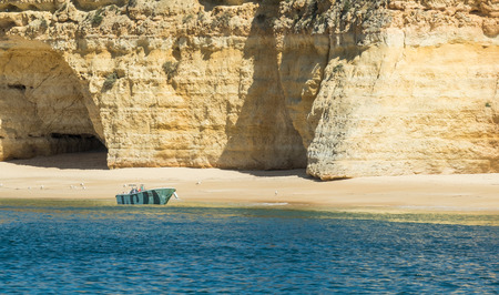 A view of the forsaken boat near the Algarve coast in Portugal, 2016の写真素材