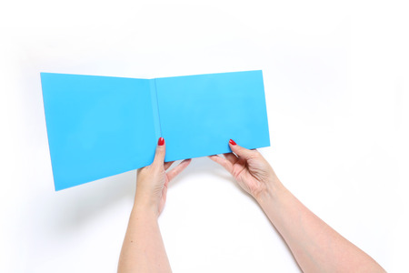 Hands Holding catalog on a white background
