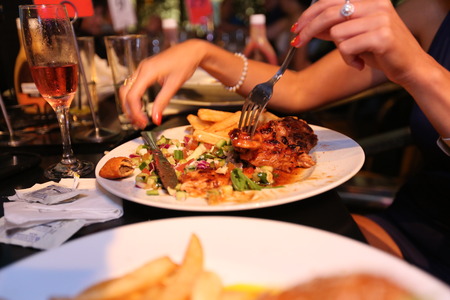 Hamburger with a glass of wine in the background