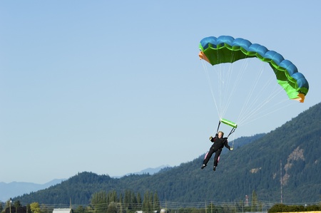 Abbotsford, British Columbia, Canada - July 24, 2010: Mature woman comes in for a landing with her parachute. The sport is not just for the young, as this mature woman comes in for a landing.のeditorial素材