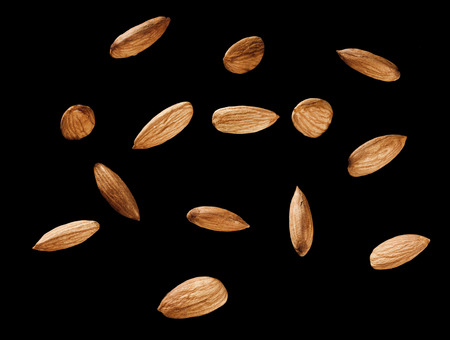 perfect fourteen almonds on black background with pathの写真素材