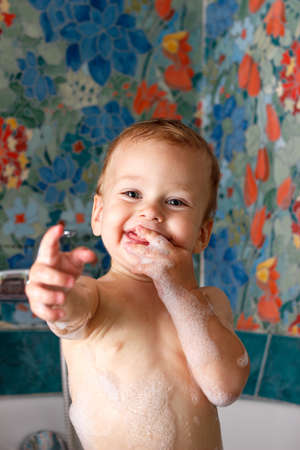 Happy baby in bathroom foamの写真素材