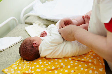 The newborns extract from maternity hospital. Swaddling, clothing, hands.の写真素材