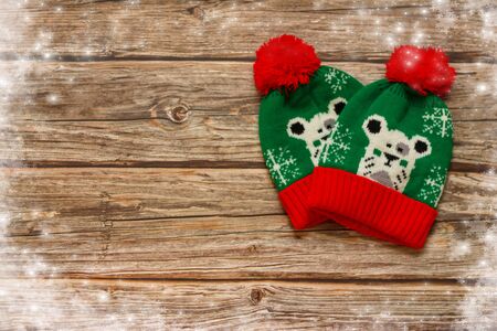 Christmas decoration. Winter Green Hat on wooden background with space for text.の写真素材