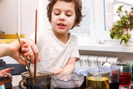 preparation for Easter. Boy paints easter eggs
