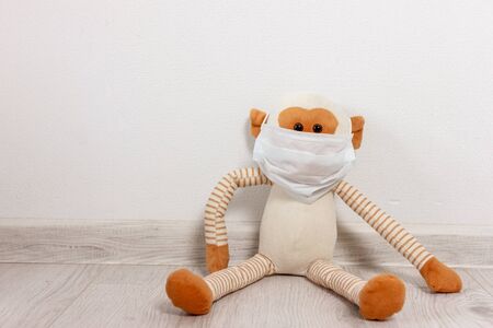 Cute monkey toy wear a blue Surgical Face Mask.の写真素材