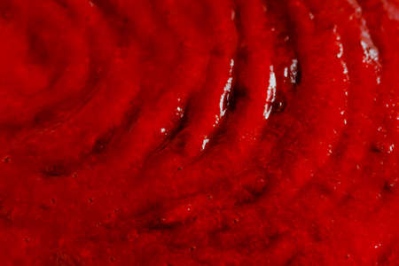 the red liquid, syrup making an abstract backgroundの写真素材