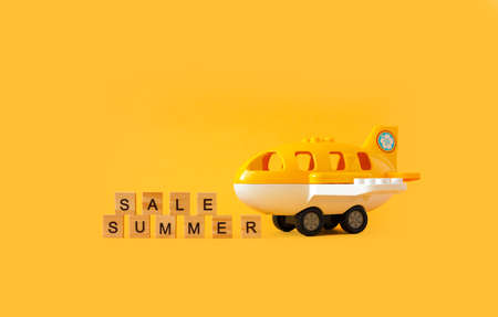 miniature plane fly toy with title SUMMER on yellowの写真素材
