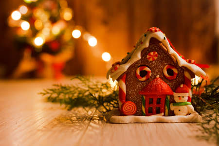 gingerbread house in branches of Christmas treeの写真素材