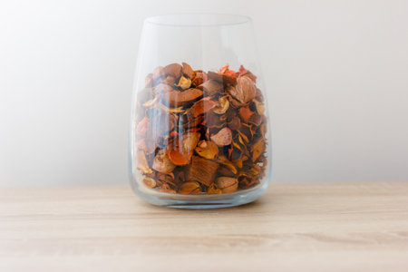 glass jar with colorful flower petals on tableの写真素材