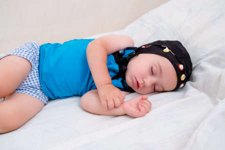 Baby patient sleeping in bed during EEG examination.