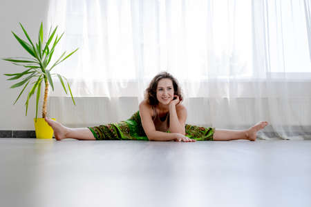attractive yogi woman doing splits on light gymの写真素材