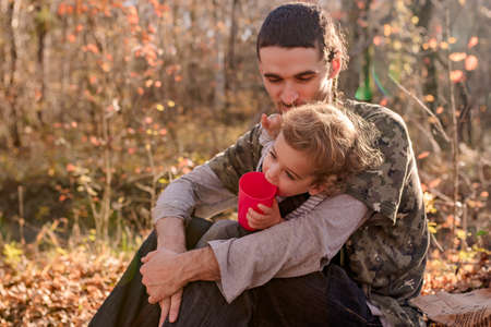 father and son in nature on a sunny warm day have happinessの写真素材