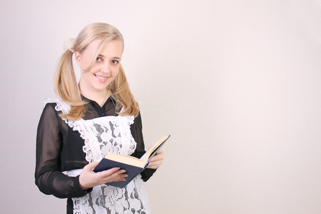 Schoolgirl senior classes  studio shot over light backgroundの写真素材