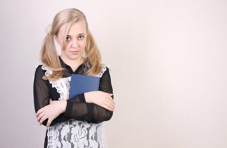 Schoolgirl senior classes  studio shot over light backgroundの写真素材