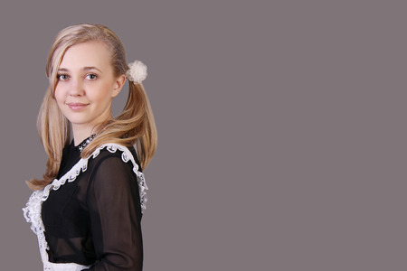 Schoolgirl senior classes  studio shot on dark backgroundの写真素材