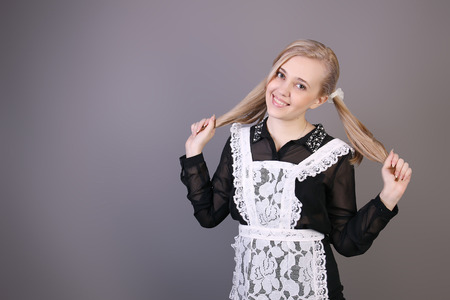 Schoolgirl senior classes  studio shot on dark backgroundの写真素材