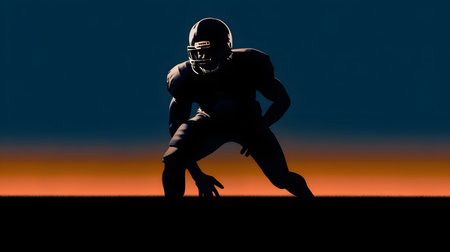 Silhouette of American football player against blue and orange sunset skyの素材