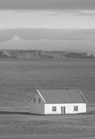 Small white house on the seashore in Iceland. Toned.の素材