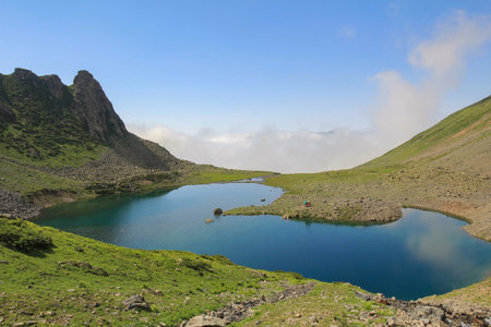Lake in the mountains. The lake is located on the slopes of the mountains.