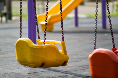 Playground with swing and chain, selective focus, shallow DOF.の写真素材
