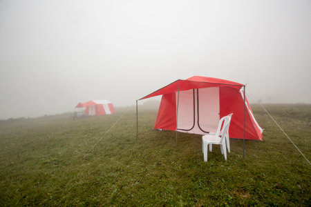 Camping tent on the meadow in the fog. camping conceptの写真素材