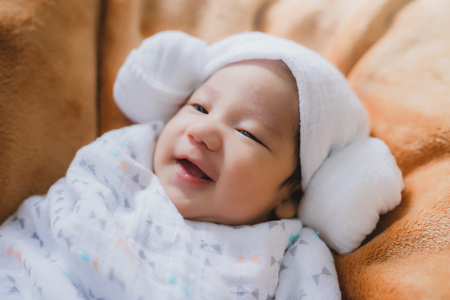 baby sleep laughing on the fabricの写真素材