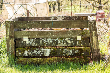 Compost heap with fertile soil in the green gardenの写真素材
