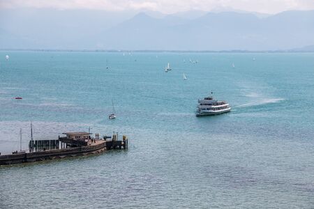 Little spit of land into the water and a little villageの写真素材