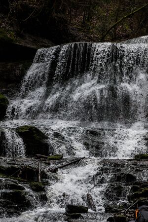 Little waterfall down the canyon in the middle of the green forest