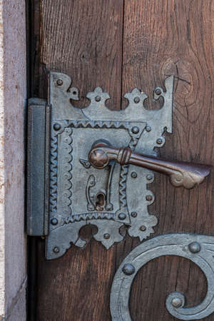 Old door with iron ornaments of a historical buildingの写真素材