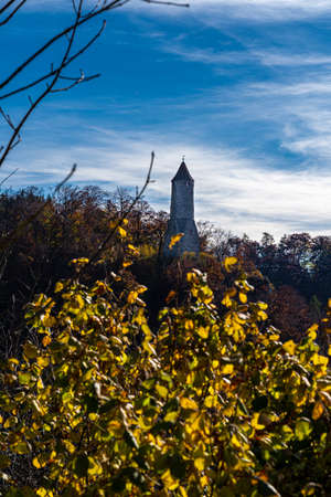 Old watchtower on a hill in the middle of the autumn forestの写真素材