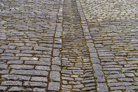 Street with gray paving stone through the historical townの写真素材