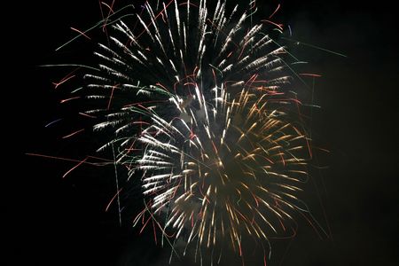 Fireworks blowing in the sky at nightの写真素材