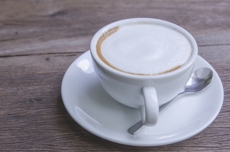 cappuccino coffee on wooden tableの写真素材