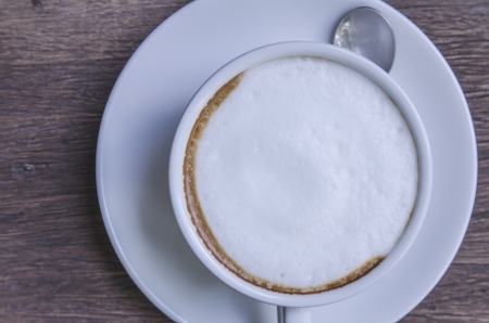 cappuccino coffee on wooden tableの写真素材